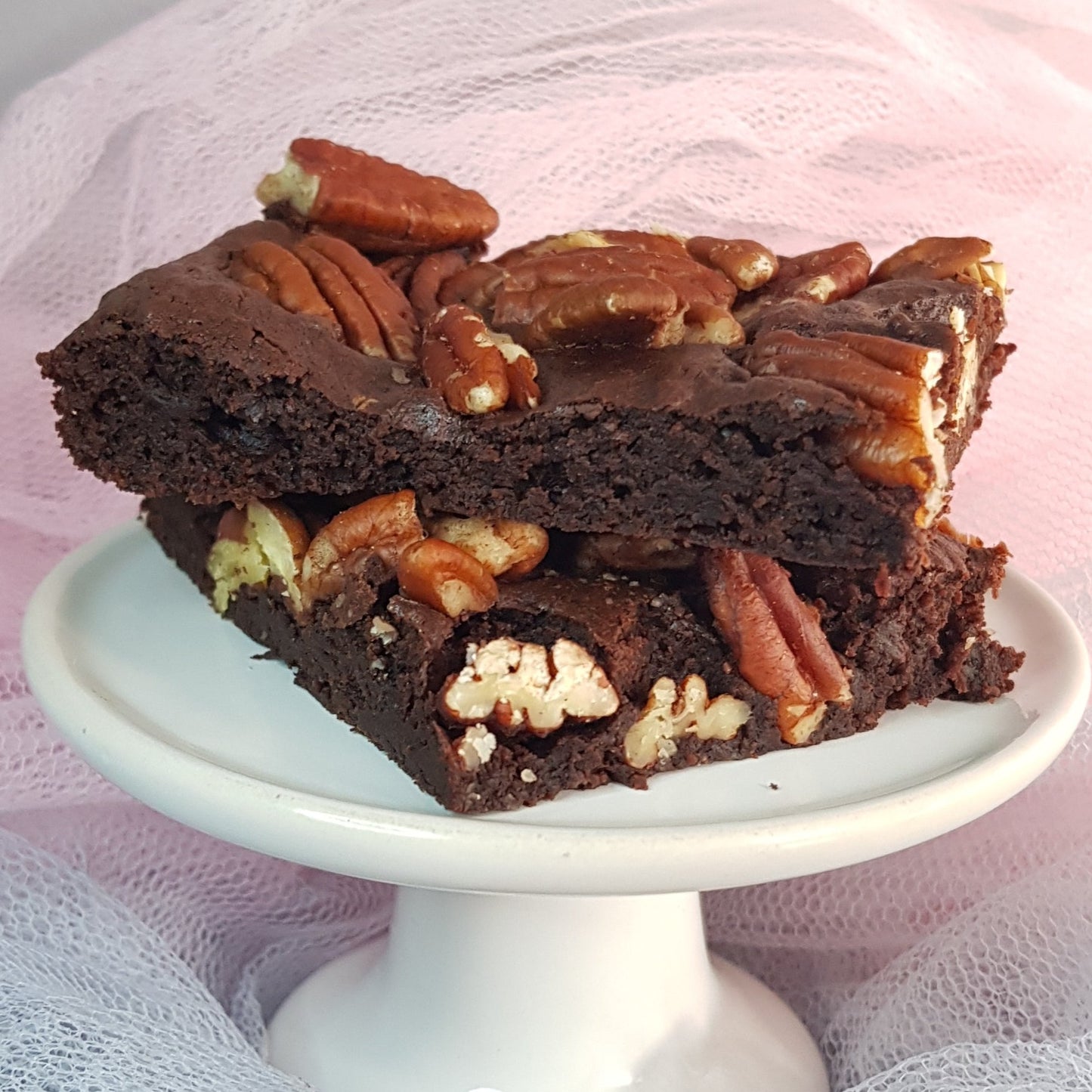 Pecan brownies on a ceramic stand