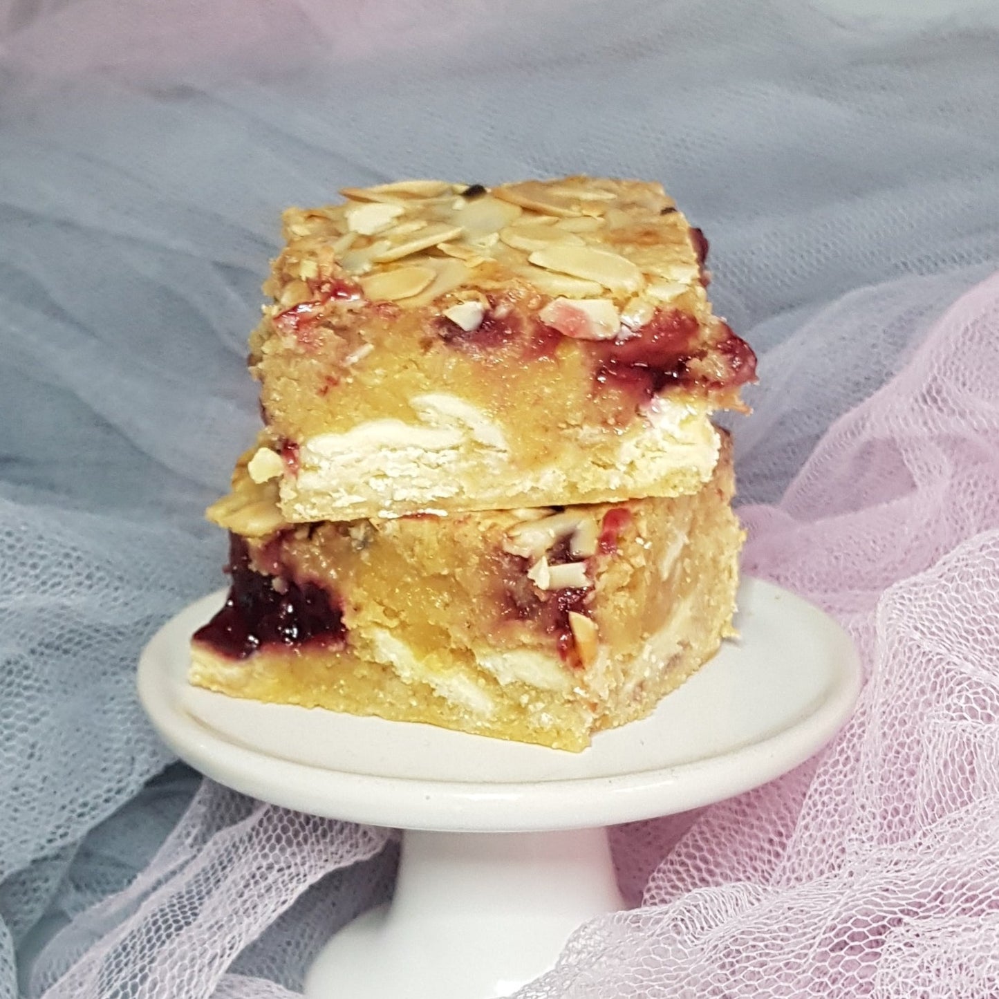 Bakewell blondies on a ceramic cupcake stand